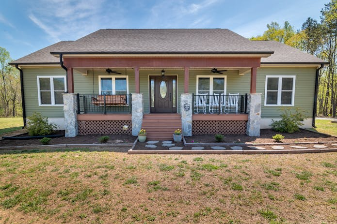 Inviting home showcasing front and covered porch. Sell My Structured Settlement Annuity.