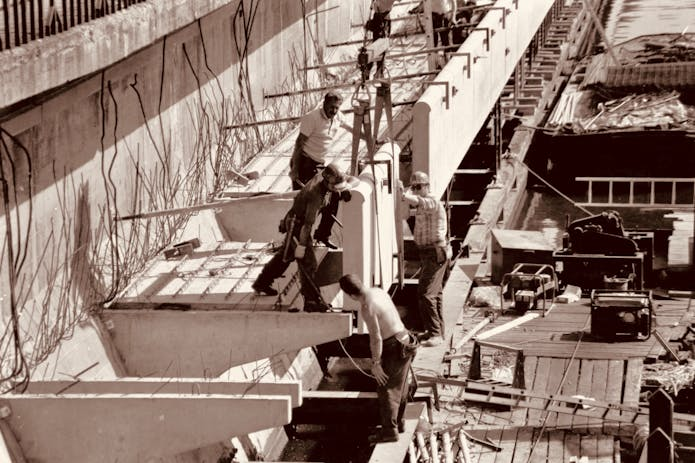 Skilled Staten Island Construction Accident Lawyer - Men renovating boat dock in classic photo.