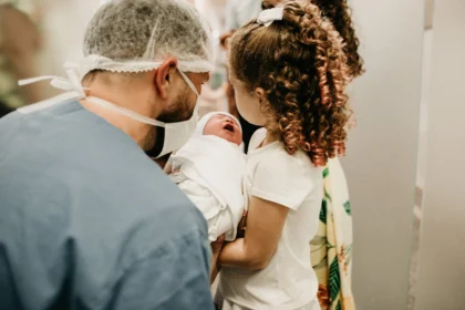 Compassionate birth injury lawyers fighting for your family's rights - an emotional image of a man, a woman, and their baby in a hospital setting.