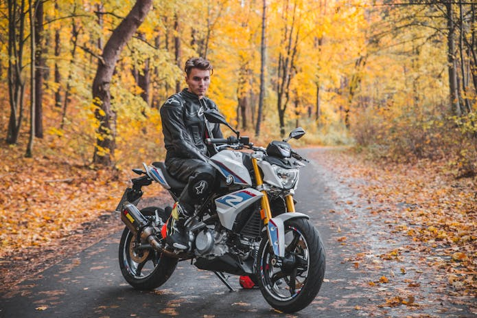 "Experience the thrill of the open road with a man in a leather jacket on a motorcycle in the fall. Get the legal support you need with a motorcycle accident attorney in Charleston, SC."