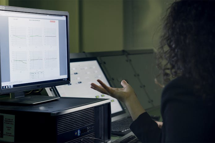  Elevate your business with premier performance management solutions for small firms - woman working on computer with data displayed.