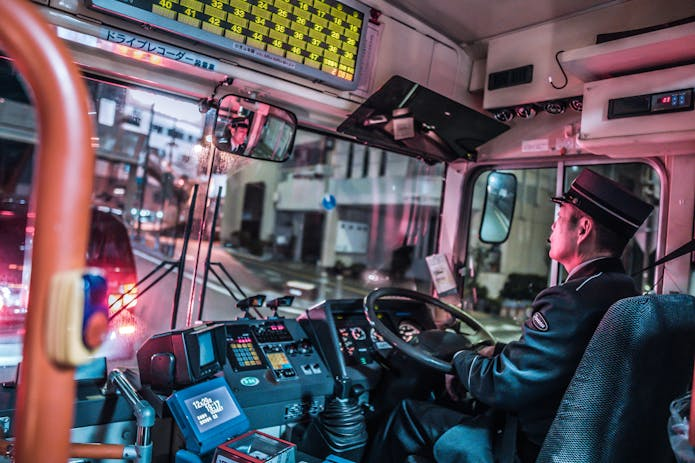 A man driving a bus at night, representing the need for a bus accident lawyer near Memphis.