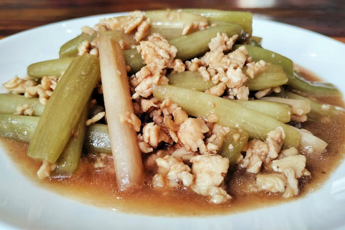 A plate of food with meat and vegetables served at Corner Bistro chilis Restaurants in New York.