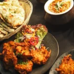 Assorted Indian cuisine presented on plates and bowls at Chilis Restaurants in New York.