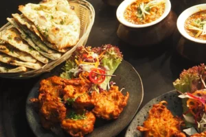 Assorted Indian cuisine presented on plates and bowls at Chilis Restaurants in New York.