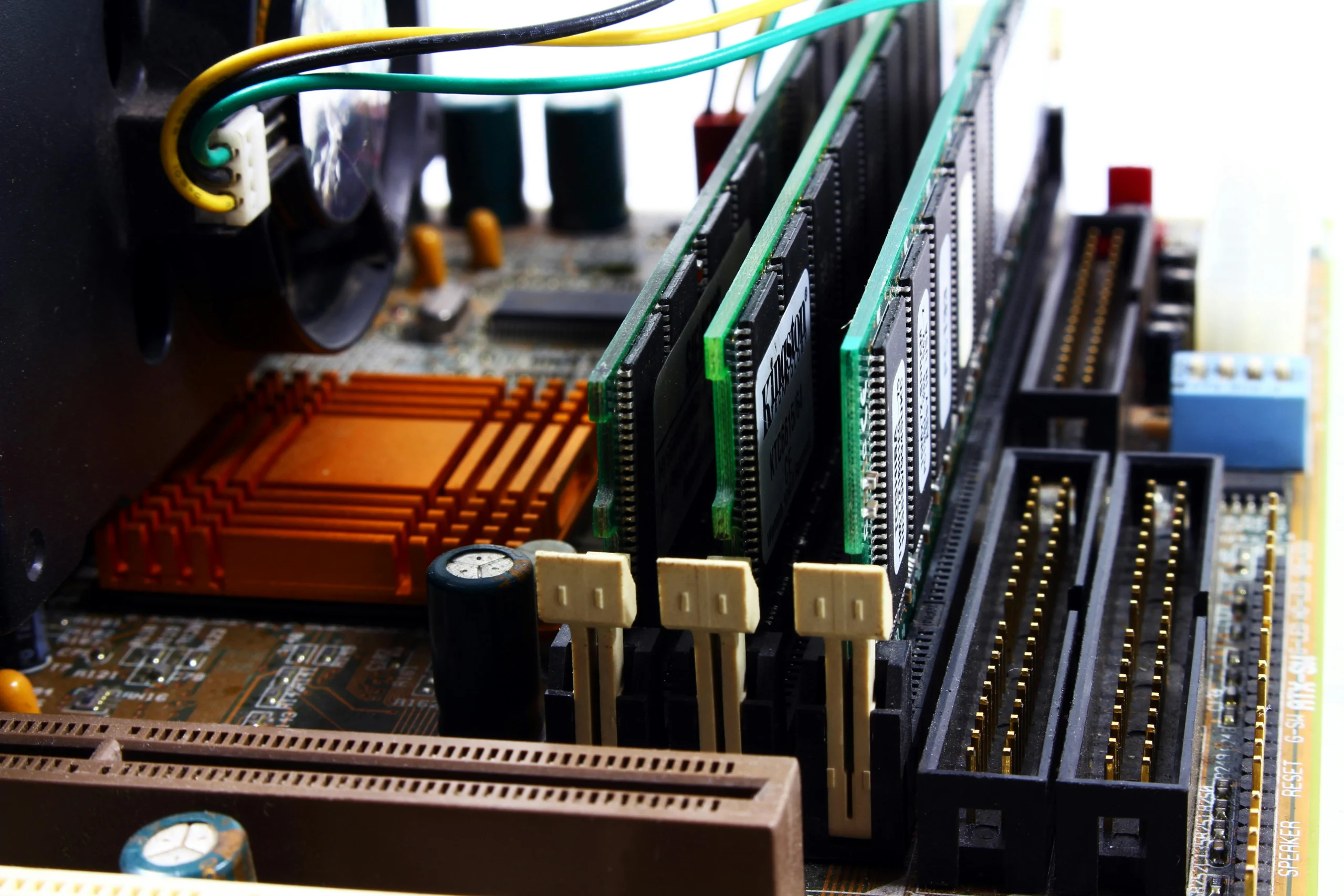 Computer motherboard close-up showing installed RAM sticks.