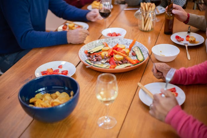 Customers eating together at a table with food in Olive Garden Restaurant.