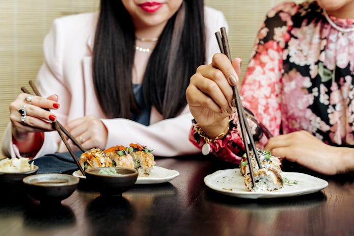 Enjoying delicious sushi at a restaurant in New York. Find fast food places nearby for a quick bite!