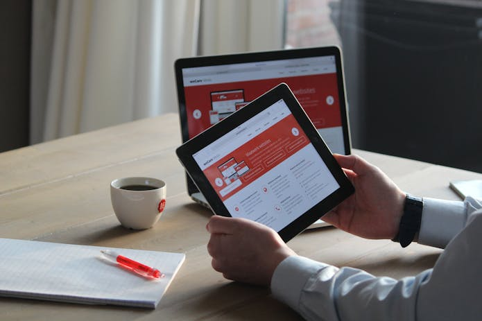  Individual engaged with a New iPad Pro tablet on a desk, highlighting the integration of technology in daily tasks.