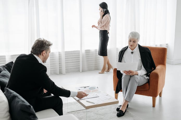 A man and woman are engaged in conversation in an office, reflecting a personal injury legal discussion.